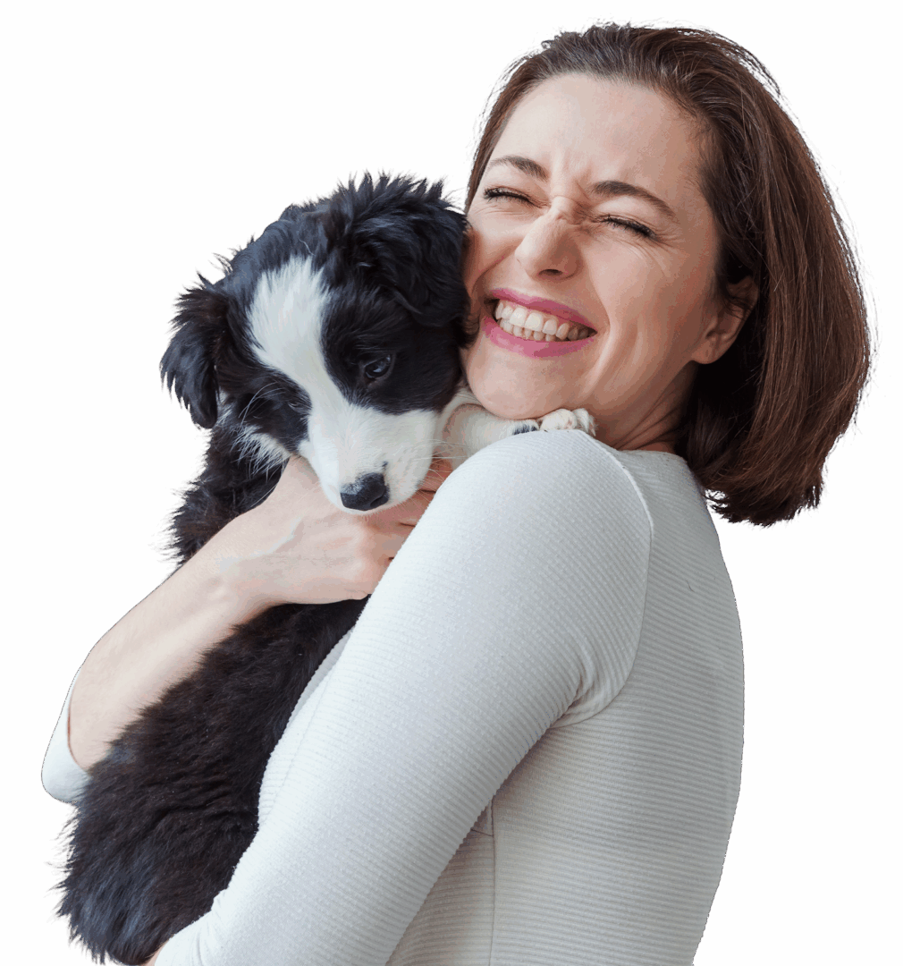 Woman hugging a cute black-and-white puppy.